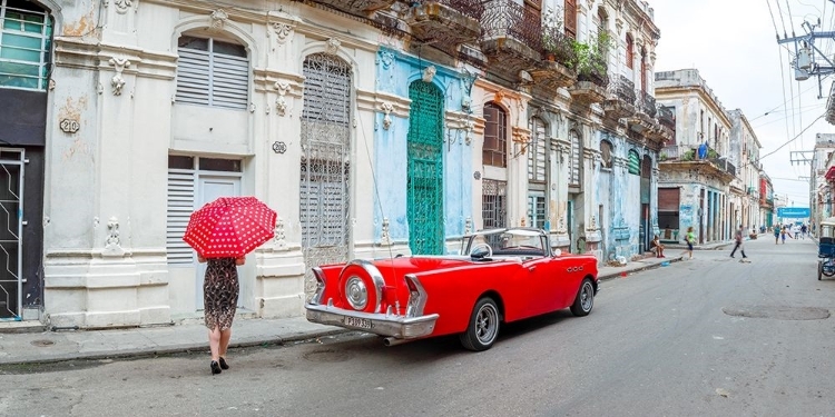 Picture of WOMAN WITH RED UMBRELLA BY A VINTAGE CAR ON THE STREET OF HAVANA, CUBA, FTBR 1851