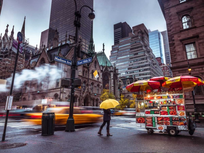 Picture of TOURIST WITH UMBRELLA ON STREETS OF LOWER MANHATTAN, NEW YORK