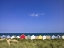 Picture of WODDEN FENCE AT BEACH WITH HUTS IN THE BACKGROUND