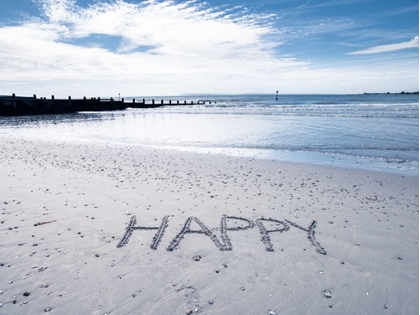Picture of HAPPY" MESSAGE WRITTEN IN SMOOTH SAND AT THE BEACH"