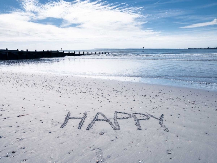 Picture of HAPPY" MESSAGE WRITTEN IN SMOOTH SAND AT THE BEACH"