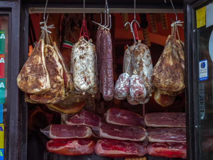 Picture of VARIOUS SALAMI HANGING IN A WINDOW OF AN ITALIAN SALAMI SHOP, ROME, ITALY