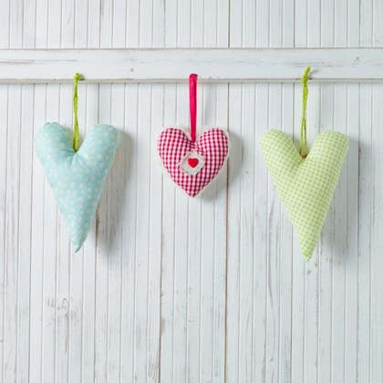 Picture of HEARTS HANGING ON WOODEN BACKGROUND