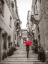 Picture of TOURIST WITH UMBRELLA IN STEPS THROUGH HOUSES IN BIRGU, MALTA