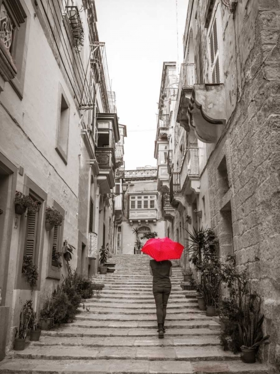 Picture of TOURIST WITH UMBRELLA IN STEPS THROUGH HOUSES IN BIRGU, MALTA