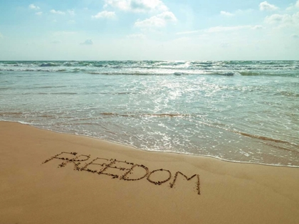 Picture of WORD FREEDOM WRITTEN IN SAND ON THE BEACH