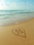 Picture of COUPLE IN HEART DRAWN ON SAND AT THE BEACH