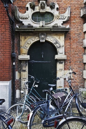 Picture of NETHERLANDS, AMSTERDAM BICYCLES BY BUILDING DOOR