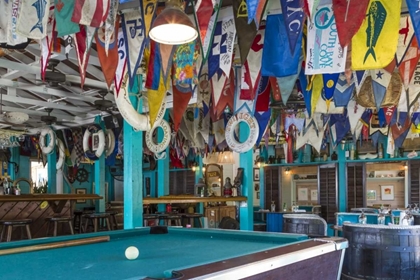Picture of BAHAMAS, EXUMA ISLAND FLAGS ON CEILING OF BAR