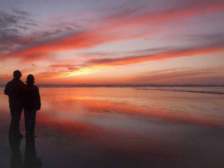 Picture of OREGON, CANNON BEACH COUPLE ON BEACH AT SUNSET