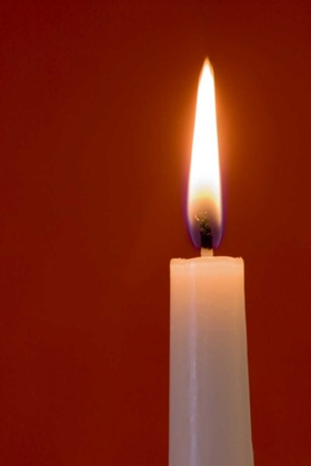 Picture of BURNING CANDLE ON RED BACKGROUND
