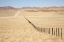 Picture of NAMIBIA, NAMIB DESERT ROAD AND FENCE IN DESERT