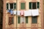 Picture of ITALY, CAMOGLI LAUNDRY HANGS ACROSS A BUILDING