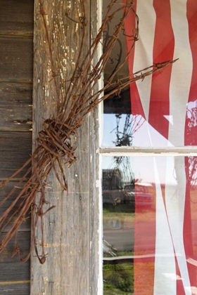 Picture of OR, SHANIKO FLAG IN WINDOW NEXT TO BARBED WIRE