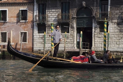 Picture of ITALY, VENICE A GONDOLIER STRIKES A POSE