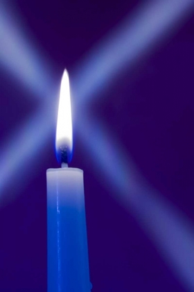 Picture of BURNING CANDLE WITH STAR BURST ON BLUE BACKGROUND