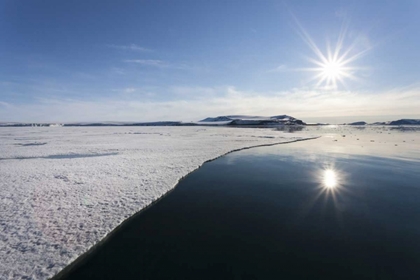 Picture of SVALBARD SUNBURST REFLECTED IN STILL WATER