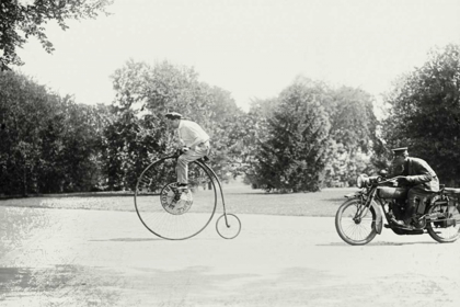 Picture of MOTORCYCLE COP CHASES A PENNY FARTHING VELOCIPEDE