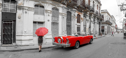 Picture of WOMAN WITH RED UMBRELLA BY A VINTAGE CAR ON THE STREET OF HAVANA-CUBA