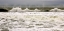 Picture of WAVES CRASHING ON THE ROCKS IN A CLOUDY DAY 