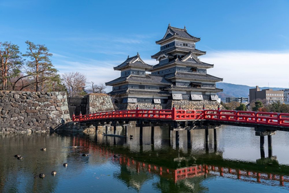 Picture of THE MATSUMOTO CASTLE AS SEEN FROM THE BRIDGE WITH THE CITY BUILDINGS IN THE BACKGROUND-JAPAN