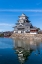 Picture of THE MATSUMOTO CASTLE AS SEEN FROM THE BRIDGE WITH THE CITY BUILDINGS IN THE BACKGROUND-JAPAN