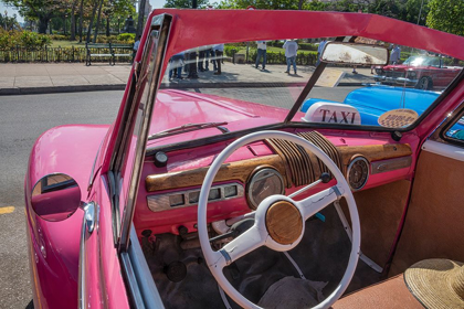 Picture of VIEW INTO DRIVERS SEAT OF CLASSIC CONVERTIBLE PINK AMERICAN CAR PARKED IN VIEJA-HAVANA-CUBA