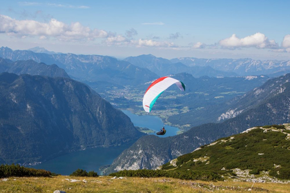 Picture of AUSTRIA-DACHSTEIN-PARAGLIDER SOARING ABOVE LAKE HALLSTATT AND THE SURROUNDING MOUNTAINS