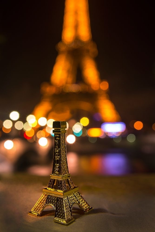 Picture of A SOUVENIR EIFFEL TOWER ON THE WALL OF THE SEINE RIVER ACROSS FROM THE REAL THING