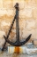 Picture of ITALY-APULIA-METROPOLITAN CITY OF BARI-GIOVINAZZO OLD RUSTED ANCHOR IN FRONT OF A STONE WALL
