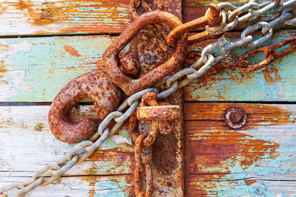 Picture of RUSTY LOCK AND CHAIN ON LIGHT BLUE WOOD