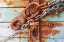 Picture of RUSTY LOCK AND CHAIN ON LIGHT BLUE WOOD