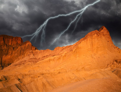Picture of CALIFORNIA-DEATH VALLEY NATIONAL PARK COMPOSITE OF LIGHTNING OVER GOLDEN CANYON AT SUNSET