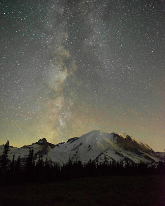Picture of THE LIGHTS OF CLIMBERS CAN BE SEEN ON THE MOUNTAIN AS THE MILKY WAY RISES BEHIND MT RAINIER