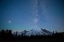 Picture of THE LIGHTS OF CLIMBERS CAN BE SEEN ON THE MOUNTAIN AS THE MILKY WAY RISES BEHIND MT RAINIER