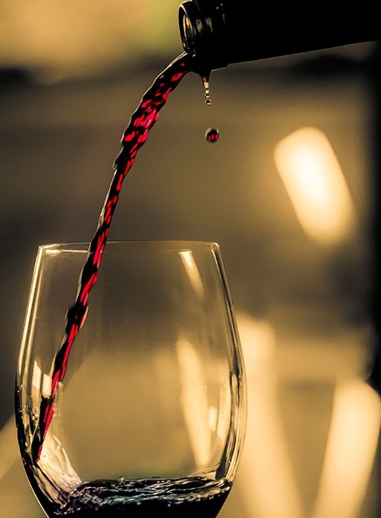 Picture of ONE DROP SHOWS AS RED WINE IS POURED INTO GLASS