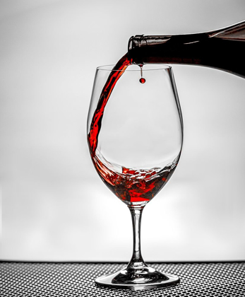 Picture of WASHINGTON STATE-SPOKANE RED WINE POURED INTO WINE GLASS CREATES PERFECT ROUND DROP,