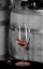 Picture of RED WINE POURING INTO IS CAPTURED IN MID-AIR BEFORE IT TOUCHES WINE GLASS