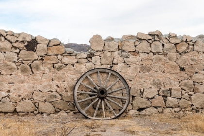 Picture of WAGON WHEEL AGAINST A STONE FENCE AT HUECO TANKS STATE PARK, NORTHWEST OF EL PASO, TX