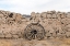 Picture of WAGON WHEEL AGAINST A STONE FENCE AT HUECO TANKS STATE PARK, NORTHWEST OF EL PASO, TX