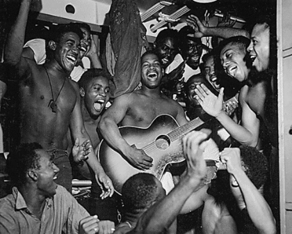 Picture of WWII MEN ABOARD THE U.S.S. TICONDEROGA HEAR THE NEWS OF JAPANS SURRENDER