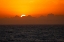 Picture of SUNSET THROUGH THE CLOUDS