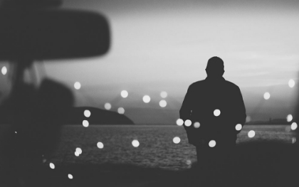 Picture of SILHOUETTE TRAVELER ON THE BACKGROUND OF THE WATER IN EVENING