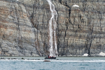 Picture of ZODIAC APPROACHING WATERFALL AND KING PENGUINS ON THE BEACH-GOLD HARBOUR-SOUTH GEORGIA-ANTARCTICA