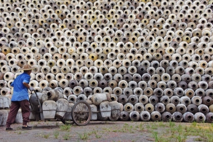 Picture of MAN PUSHING CART LOADED WITH WINE JARS TO THE BIG PILE IN A WINERY-ZHEJIANG PROVINCE-CHINA