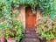 Picture of ITALY-TUSCANY-PIENZA DOORWAY SURROUNDED BY FLOWERS