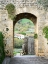 Picture of ITALY-CHIANTI-MONTERIGGIONI LOOKING OUT AN ARCHED ENTRANCE INTO THE WALLED TOWN
