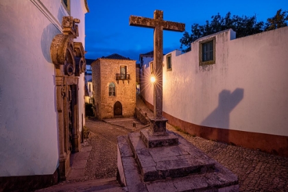Picture of EUROPE-PORTUGAL-OBIDOS-CHURCH AND CROSS ON COBBLESTONE STREET AT SUNSET