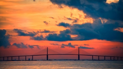 Picture of THE SKYWAY BRIDGE OVER THE GULF OF MEXICO WITH THE REDS AND ORANGES OF THE SUNRISE IN THE SKY