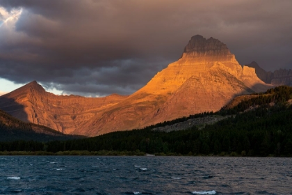 Picture of USA-MONTANA-GLACIER NATIONAL PARK STORMY SUNRISE ON MT WILBUR AND LAKE
